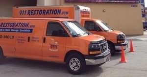 Water Damage Cypress Restoration Vans At Commerical Job Location